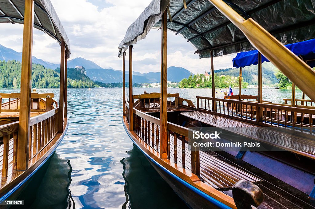 Passengers boats, Lake Bled, Julian Alps, Slovenia Lake Bled (Blejsko jezero) with Santa Maria Church on the island. Lake in the Julian Alps in northwestern Slovenia is a very popular tourist destination. Traditional special boats "Pletna" in foreground. Beauty In Nature Stock Photo
