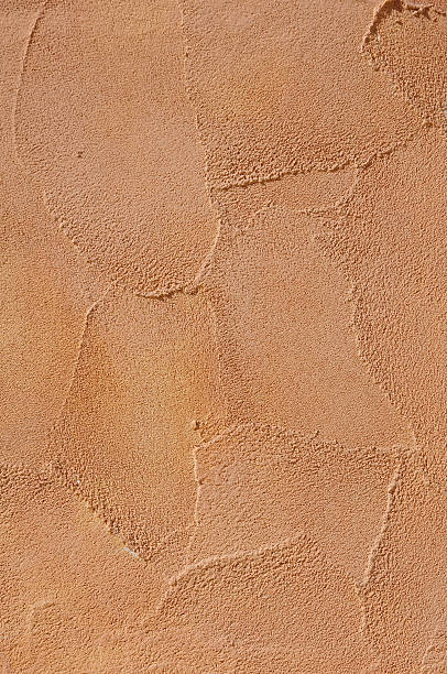 istock Orange relief plaster on wall closeup 471520032