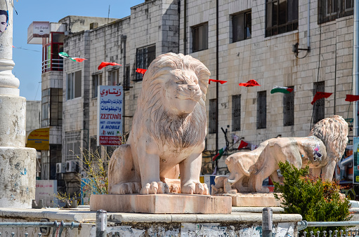 Ramallah, West Bank, Israel ‐ April 2, 2012: The marble lion sculptures at the Manara, the central traffic roundabout and Ramallah's central square. Located 10 miles north of Jerusalem, Ramallah is the seat of the Palestinian de facto government.