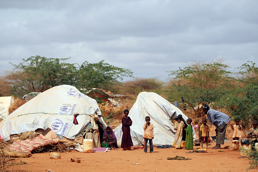 Dadaab, Kenya - August 14, 2011: Newly arrived Somalian refugees in daily life in Dagahaley refugee camp which makes up part of the giant Dadaab refugee settlement on August 14, 2011 in Dadaab, Kenya. The refugee camp at Dadaab, located close to the Kenyan border with Somalia, was originally designed in the early 1990s to accommodate 90,000 people but the UN estimates over 4 times as many reside there. The ongoing civil war in Somalia and the worst drought to affect the Horn of Africa in six decades has resulted in an estimated 12 million people whose lives are threatened.