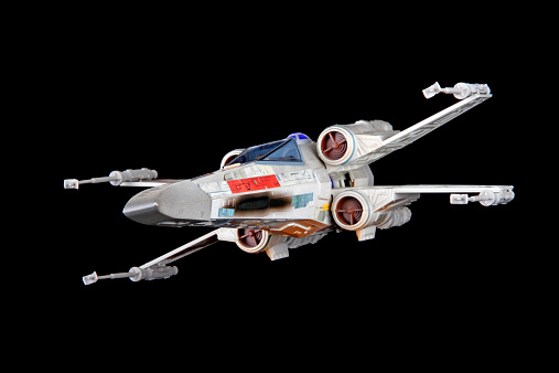 Vancouver, Canada - April 12, 2013: An X-Wing Fighter from the Star Wars film franchise, posed on a black background. The toy is created by Hasbro.