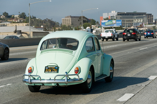 Los Angeles, California, USA - April 22, 2013: A solo commuter drives a vintage Volkswagen Beetle down Interstate 10 freeway near downtown Los Angeles.