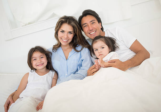 istock Beautiful family looking happy in bed 471521588