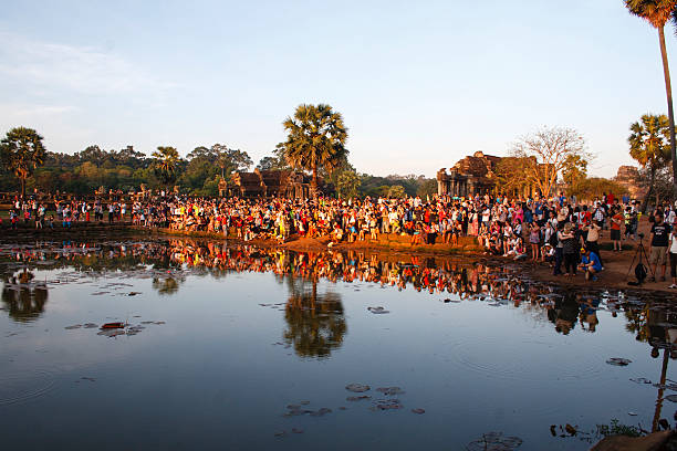 Siem Reap, Cambodia - February 10, 2016: Tourists wait for the sunrise at the North Library of Angkor Wat