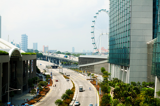 Singapore, Singapore - September, 3th 2012: Aerial view in front of Marina Bay Sands at right side down to Bayfront Avenue. Traffic is ruling. In background is bridge of East Coast Parkway leading out to Kallang. At right side is Singapore Flyer behind MBS hotel.
