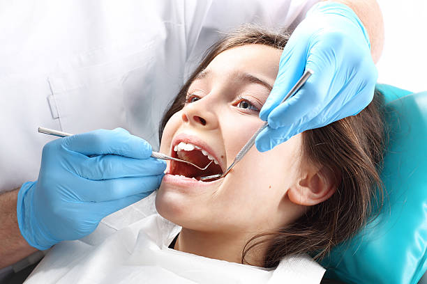istock Young lady undergoing a dental exam 471524164