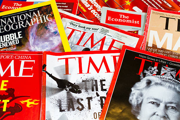 Popular Magazines Shanghai, China - May 18, 2013: Popular Magazines in English language displayed. These magazines include Time, The Economist and National Geographic. Magazines are a great way to learn news, culture and short stories. They generate the majority of their income through advertising.  newspaper seller stock pictures, royalty-free photos & images