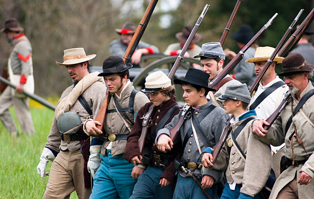 Civil War Re-enactment Union Soldiers March Holding Muskets During Battle Steilacoom, Washington, USA - May 1, 2010: A group of union soldiers march during a Civil War re-enactment in the Pacific Northwest. civil war enactment stock pictures, royalty-free photos & images