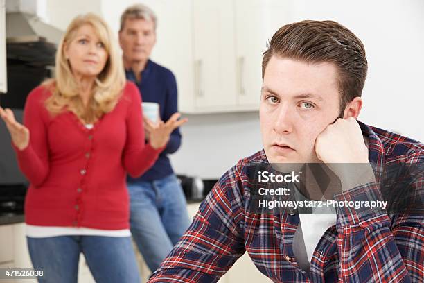 Mature Parents Frustrated With Adult Son Living At Home Stock Photo - Download Image Now