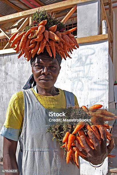 Portrait Of A Carrot Seller Stock Photo - Download Image Now - Adult, African Ethnicity, Afro-Caribbean Ethnicity