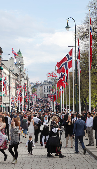 Oslo, Norway - May 17, 2013: Groups of people in the main street, some dressed in national costumes for the celebration of the 17th May, Norway's Constitution Day.