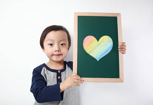 istock Child holding blank black chalkboard 471526706