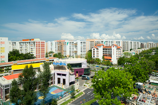 Singapore, Singapore - May 19, 2013: Commuters in vehicles at a busy traffic junction, the pedestrian crossing the roads.