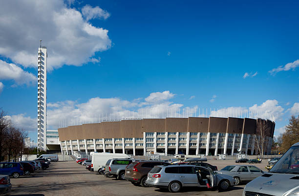Helsinki Finland Olympic Stadium Helsinki, Finland - April 28, 2013: Olympic Stadium built for the 1952 Games. A woman is getting out of a car in the foreground at the parking lot. 1952 1952 stock pictures, royalty-free photos & images