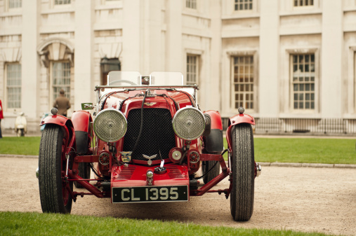 London, England, United Kingdom– May 19, 2013: Front angle of vintage prewar Aston Martin Ulster, photographed against old Baroque architecture facade