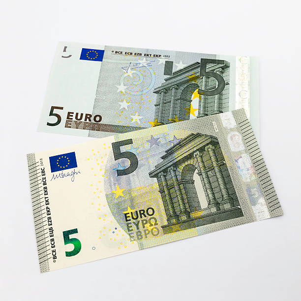 Wierden, the Netherlands - May 17, 2013 : The new five Euro banknote, issued in 2013, on top of the old banknote from 2002.