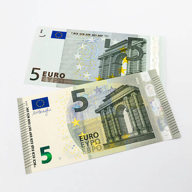 New 2013 five Euro banknote on top of previous model Wierden, the Netherlands - May 17, 2013 : The new five Euro banknote, issued in 2013, on top of the old banknote from 2002. five euro banknote photos stock pictures, royalty-free photos & images