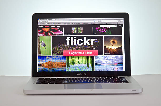 New website Flickr Pescara, Italy - May 21, 2013: The morning of 21 May the website flick restailing your web page with a new graphic e solution for users. The new site is accessible for desk pc and tablet. In this photo the homepage on the laptop. Flickr is the worlds largest photo sharing website. Members from all around the world can upload their photos to share. Flickr stock pictures, royalty-free photos & images