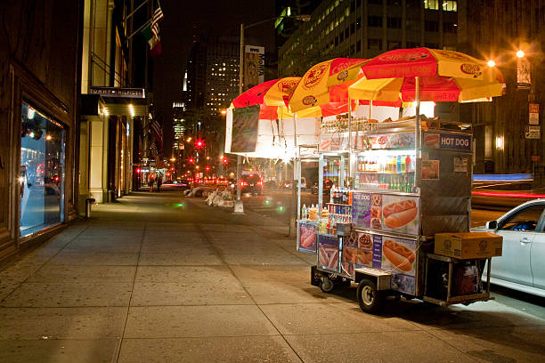 Late night food cart break in NYC. New York City, New York - April 29, 2013: hot dog stand stock pictures, royalty-free photos & images