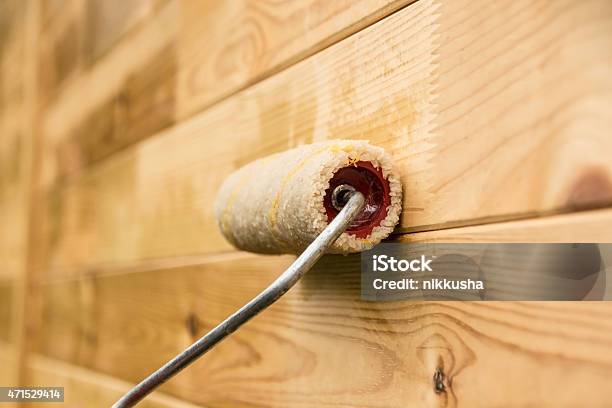 Painting The Wooden Wall With A Paint Roller Stock Photo - Download Image Now - 2015, Blank, Brushing