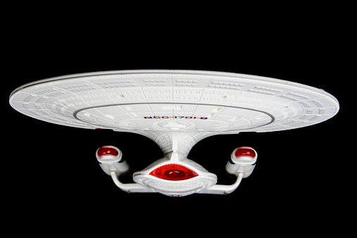 Vancouver, Canada - March 25, 2013: A toy replica of the USS Enterprise NCC-1701-D, the starship from Star Trek: The Next Generation, against a black background.