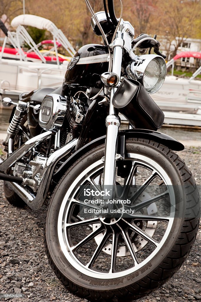 Harley Davidson Sportster Greenwood Lake NY, USA - April 28, 2013: Harley Davidson Sportster 1200 parked at lake front. Greenwood lake is a popular destination for motorcyclist and boaters alike. Alloy Wheel Stock Photo