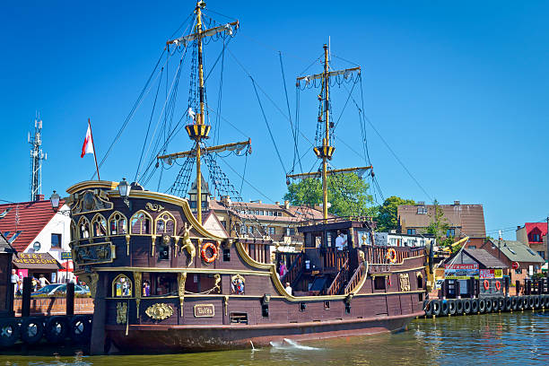 Łeba, Poland - August 03, 2011: Medieval tourist boat Ustka in Łeba harbour.  Tourist Boat  transports tourists across the Łeba harbour to the Baltic Sea for a cruise