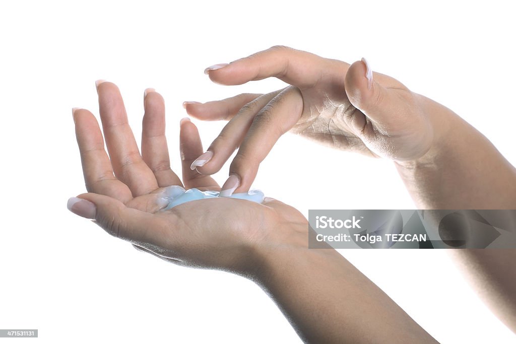 Beautiful female hand applying moisturiser (Isolated) Beautiful female hand applying moisturiser 20-24 Years Stock Photo