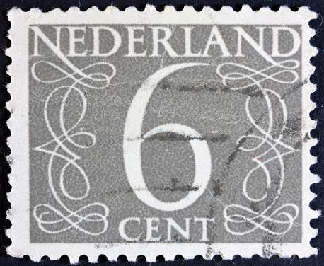 A stamp printed in the Netherlands, shows the value of a postage stamp surrounded with decorative swirls, from series \