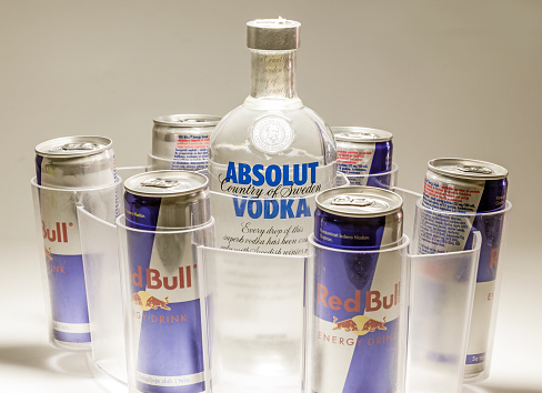 Cacak, Serbia - May 20, 2013: Six Red Bull Cans and Absolut Vodka, studio isolated. 
