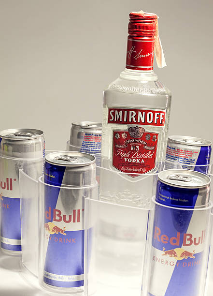 Cacak, Serbia - May 20, 2013: Five Red Bull Cans and Smirnoff Vodka, studio isolated. 