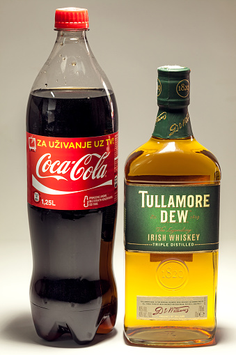 Cacak, Serbia - May 20, 2013: Coca Cola and Tullamore DEW Whiskey, studio isolated. 