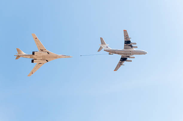 Il-78 tanker and Tu-160 bomber demonstrate refueling against sky background Moscow, Russia - May 9, 2013: Ilyushin Il-78 (Midas) aerial refueling tanker and Tupolev Tu-160 (Blackjack) supersonic heavy strategic bomber demonstrate refueling against blue sky background on display during parade festivities devoted to 68th anniversary of Victory Day. tu160 stock pictures, royalty-free photos & images