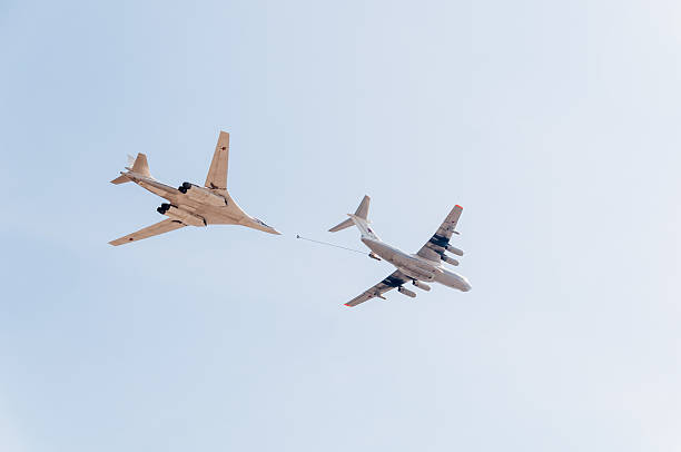 Il-78 tanker and Tu-160 bomber demonstrate refueling against sky background Moscow, Russia - May 9, 2013: Ilyushin Il-78 (Midas) aerial refueling tanker and Tupolev Tu-160 (Blackjack) supersonic heavy strategic bomber demonstrate refueling against blue sky background on display during parade festivities devoted to 68th anniversary of Victory Day. tu160 stock pictures, royalty-free photos & images
