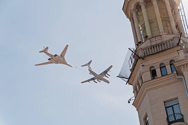 Il-78 tanker and Tu-160 bomber demonstrate refueling against sky background Moscow, Russia - May 9, 2013: Ilyushin Il-78 (Midas) aerial refueling tanker and Tupolev Tu-160 (Blackjack) supersonic heavy strategic bomber demonstrate refueling against blue sky background on display during parade festivities devoted to 68th anniversary of Victory Day. tu160 stock pictures, royalty-free photos & images