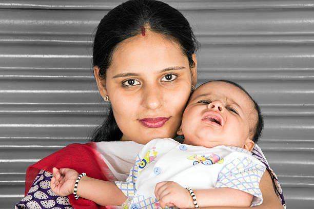 Indian Mother Holding Baby in Her Hand.