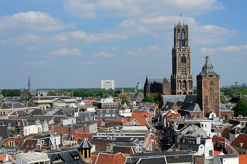 Canal in Bruges and famous Belfry tower on the background in a beautiful summer day, Belgium