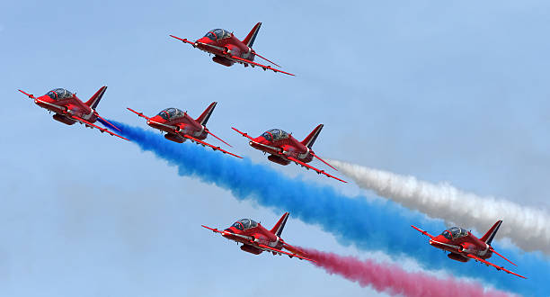 Duxford, Cambridgeshire, United Kingdom - May 26th, 2013: Hawk Aircraft of the Royal Air Force Red Arrows aerobatic display team putting on the smoke at the Duxford Spring Airshow