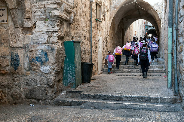 Palestinian school children in East Jerusalem East Jerusalem, Occupied Palestinian Territory/Israel - October 20, 2010: Palestinian schoolchildren walk from their homes to school in the Muslim Quarter of the Old City of Jerusalem. East Jerusalem was occupied by Israel in the Six-Day War (1967) and unilaterally annexed shortly afterwards. The status of East Jerusalem is contentious, and its annexation is not legally recognized by most of the world. east jerusalem stock pictures, royalty-free photos & images