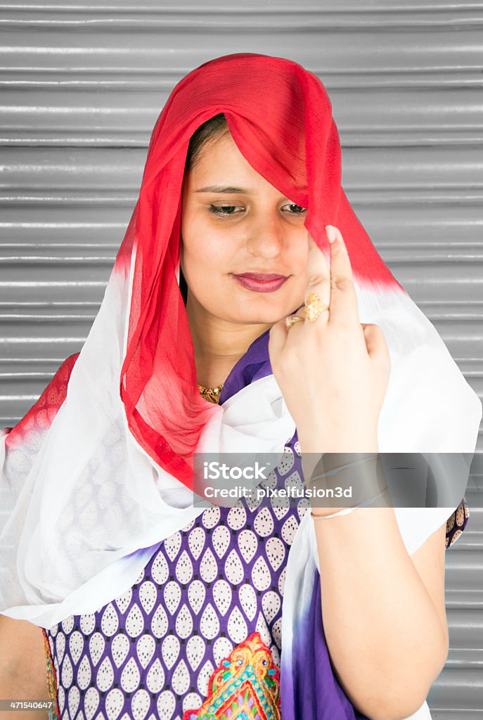 Newly Married Young Women in Traditional Indian Dress Newly Married Young Indian Women in Traditional Indian Dress Holding Dupatta in her hand. She is looking little shy while holding dupatta in her hand. 20-24 Years Stock Photo