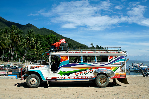 Palawan, Philippines - May 23, 2007: Colorful jeepney passenger vehicle parked in Sabang marina, jeepneys are used for transporting passengers and freight throughout the philippines. Sabang marina is a busy fishing port and also the strart point for tourist trips to the underground river by boat.