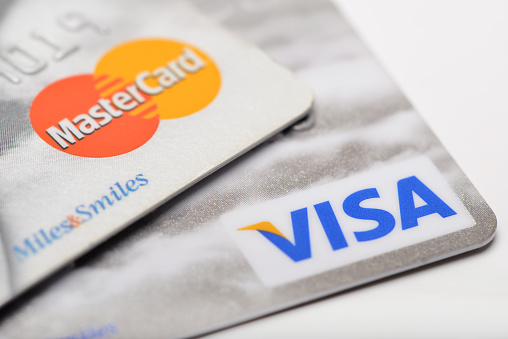 Ankara, Turkey - October 17, 2012 : Studio shot of two major credit cards Visa and MasterCard over white background