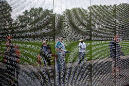 Washington D.C., United States - July 14, 2010: Names of Vietnam war victims on Vietnam Veterans Memorial on July 14,2010 in Washington DC, USA. The names are in chronological order, from first casualty in 1959 to last one in 1975.