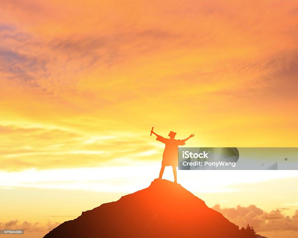 happy college graduate student Silhouettes of excited happy college graduate student stand on the top of mountains Mountain Stock Photo