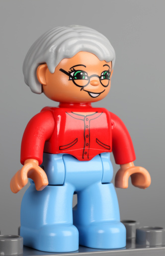 Tambov, Russian Federation - February 28, 2013: Lego Duplo grandmother figure on grey background. Studio shot. 