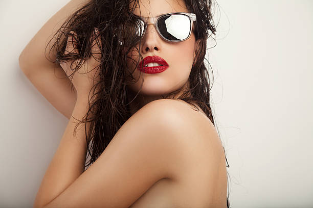 istock A beautiful young woman with red lips wearing sunglasses 471544534