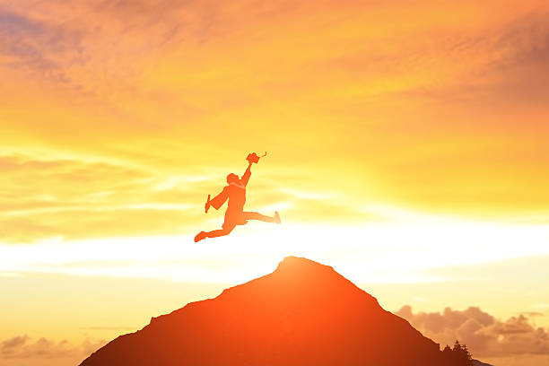 istock happy college graduate student jump 471544672