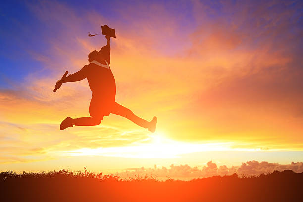 istock happy college graduate student jump 471544720