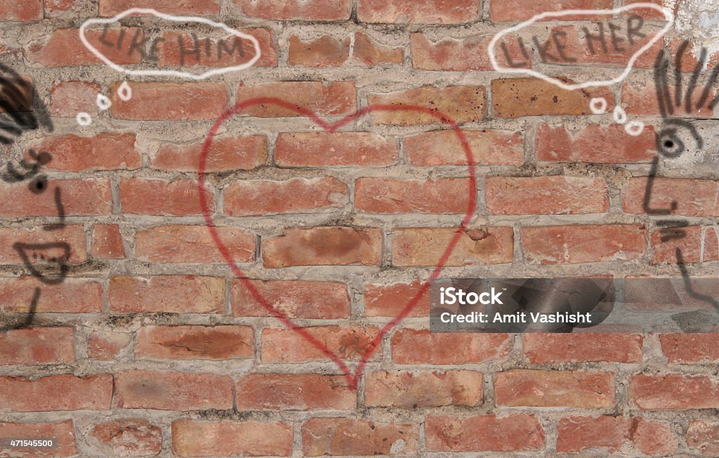 Love on brick wall Expressing love on brick wall with hand drawn subject. Image showing expression of girl and boy making love on brick wall. 2015 Stock Photo