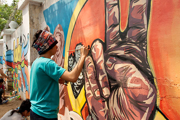 Wall painting Quezon City, Philippines - June 1, 2013: An attempt to make 3,770 meters of peace mural along the major national highway in Manila, which will be considered the longest peace mural in the world surpassing the Guinness record "Chile Wall of Peace" which is only 1,000 meters. The project " A journey of peace" was started May 26th, 2013 with several peace advocates groups including the Armed Forces of the Philippines. guinnes stock pictures, royalty-free photos & images
